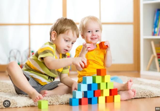 Happy child playing with wooden toys